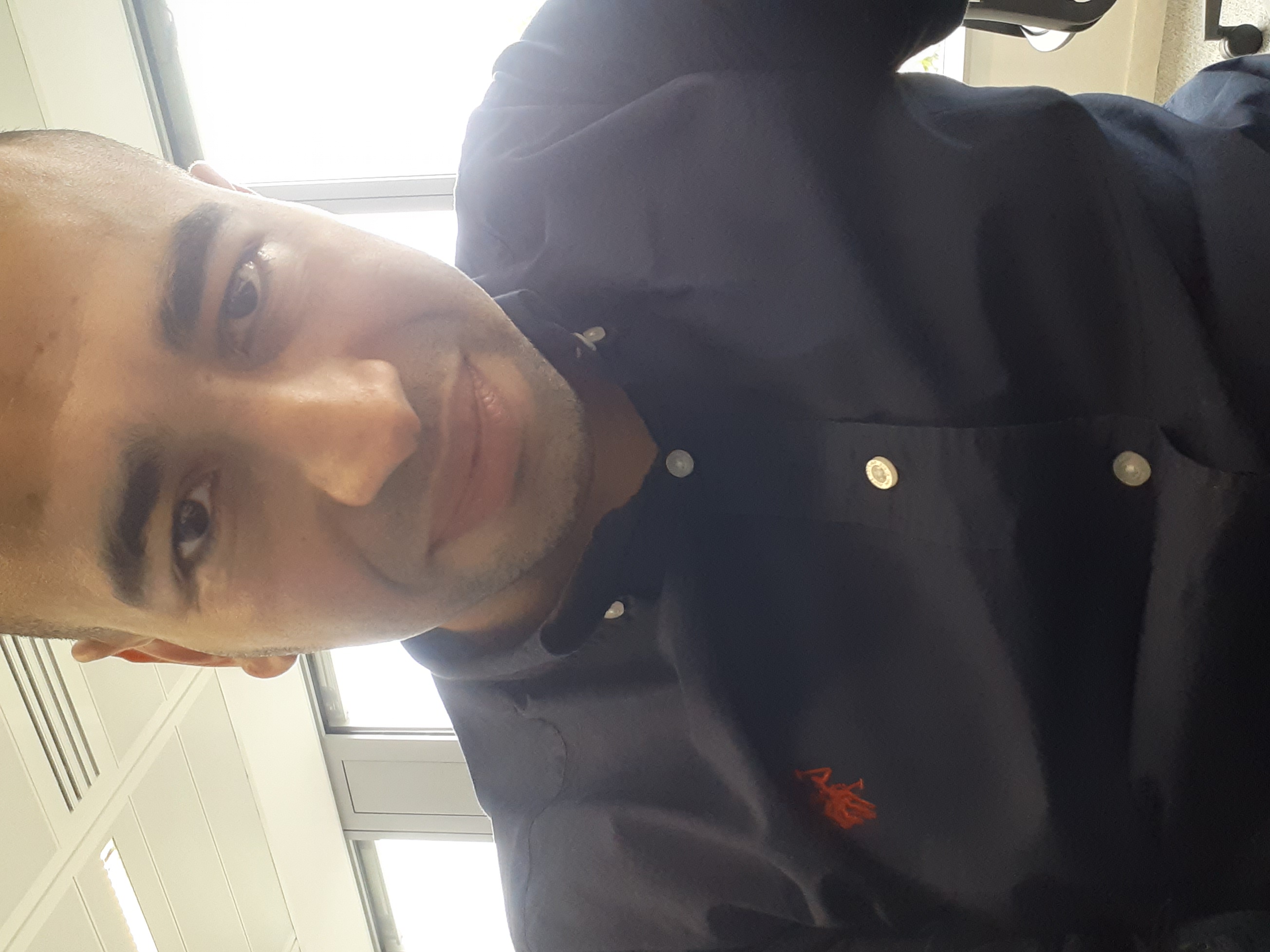 Fayçal in a navy shirt